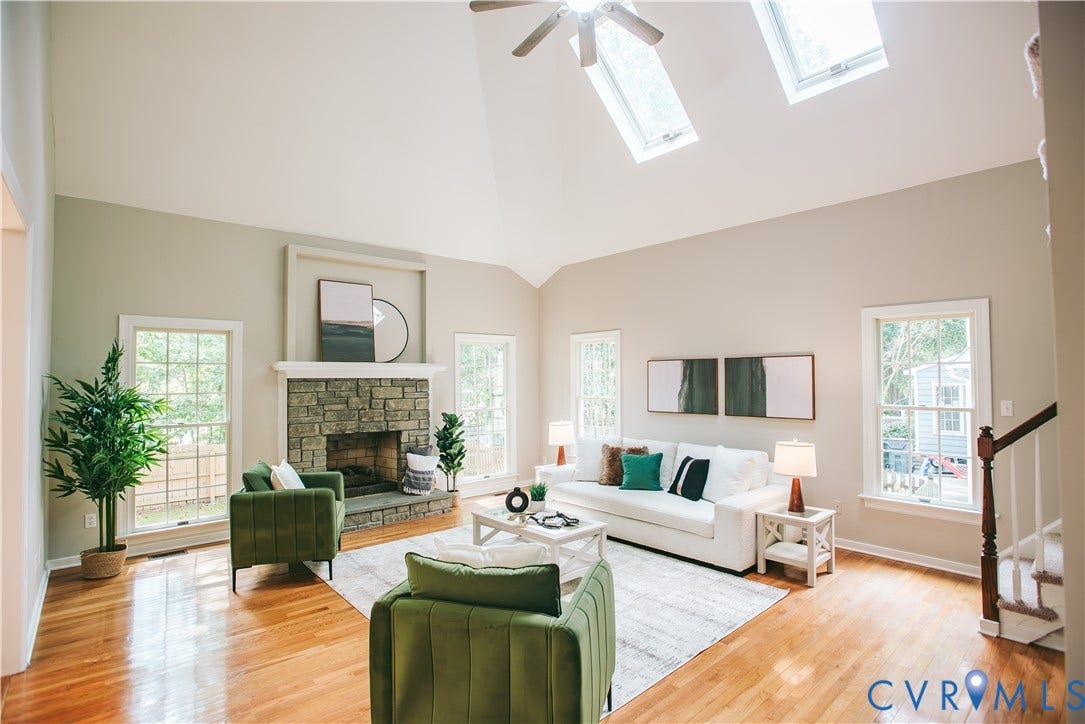 3700 Bremerton Drive, Wellesley, Henrico, VA 23233 Vaulted ceiling with skylights, stone-clad fireplace with mantel, wood-finish flooring, multiple windows, and a ceiling fan
