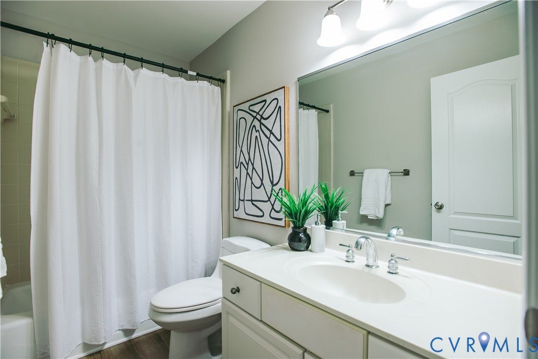 3700 Bremerton Drive, Wellesley, Henrico, VA 23233 White vanity with integrated sink, chrome faucet, and wood-finish flooring