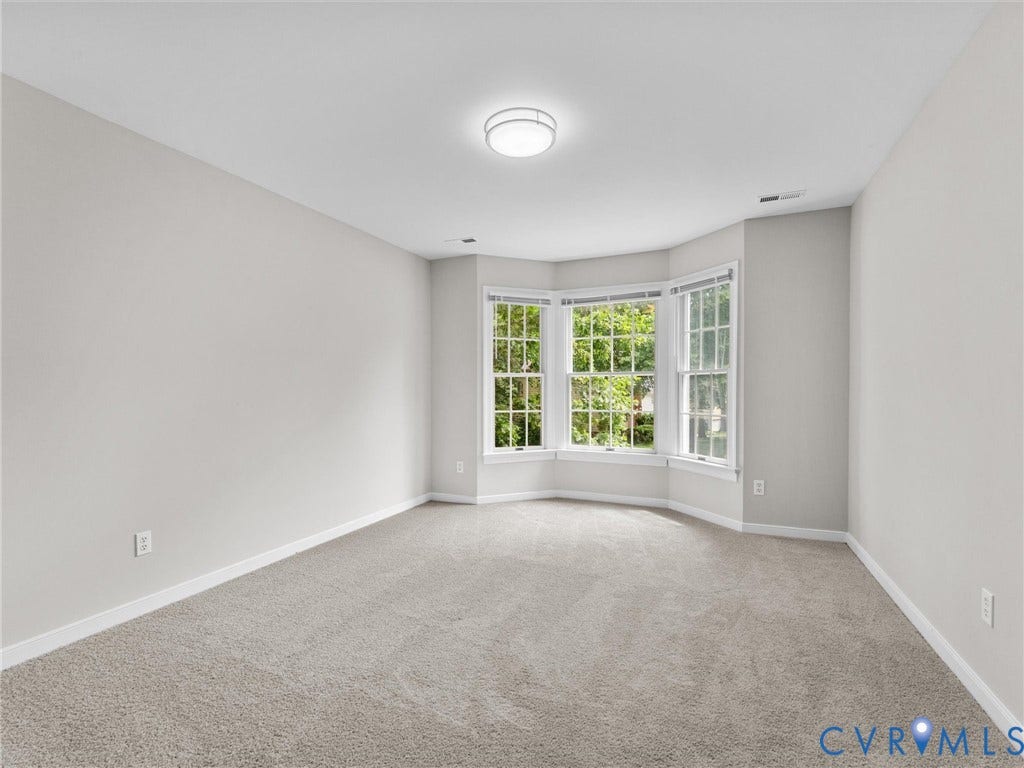 3700 Bremerton Drive, Wellesley, Henrico, VA 23233 Bay window with multiple panes, neutral wall paint, light-toned carpeting, and a flush-mount ceiling light fixture