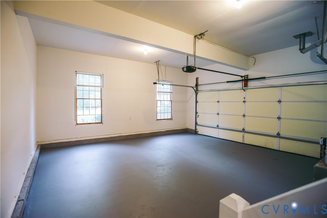3700 Bremerton Drive, Wellesley, Henrico, VA 23233 Two-car garage with painted concrete flooring, two double-hung windows, and an automatic garage door opener