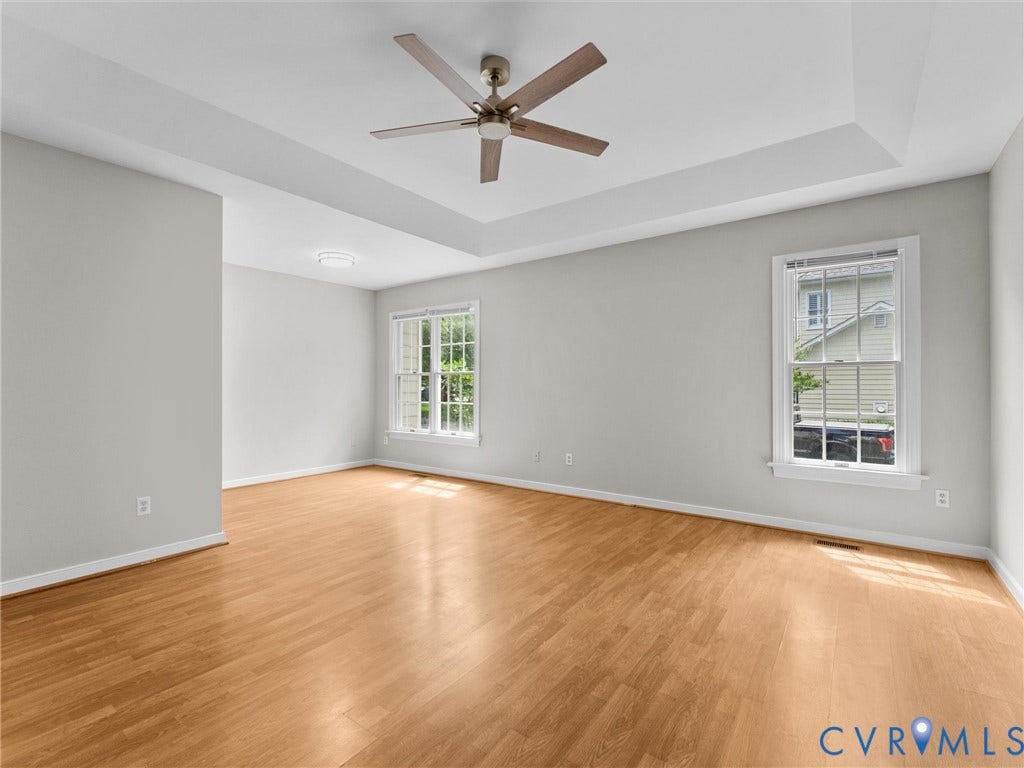 3700 Bremerton Drive, Wellesley, Henrico, VA 23233 Tray ceiling with a ceiling fan, light wood-finish flooring, and multiple windows