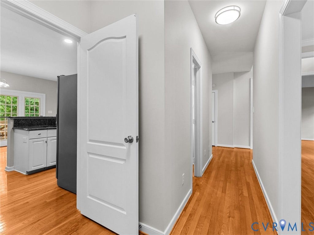 3700 Bremerton Drive, Wellesley, Henrico, VA 23233 Hardwood flooring throughout, white interior doors, recessed lighting, white cabinetry, and a dark stone countertop