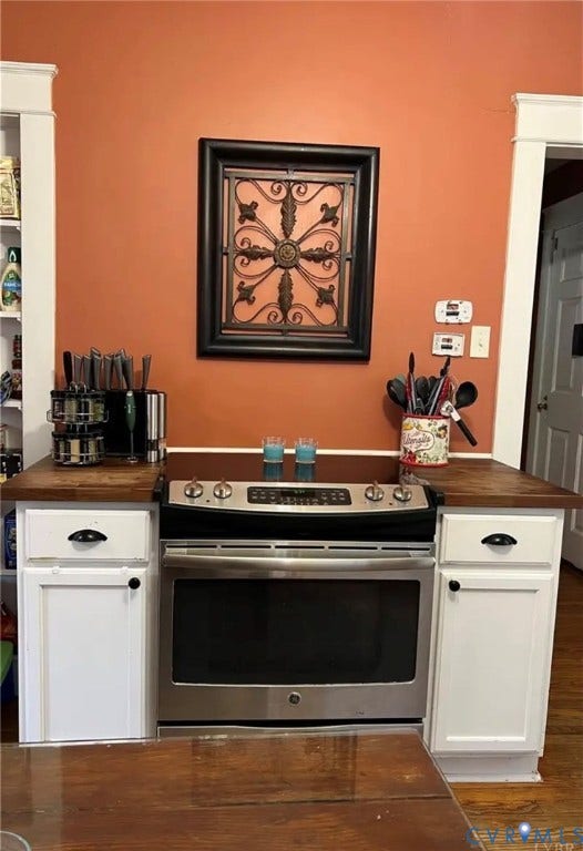13232 W James Anderson Highway, Courthouse Area, Buckingham, VA 23921 Stainless steel range, wood-finish countertops, and white lower cabinetry
