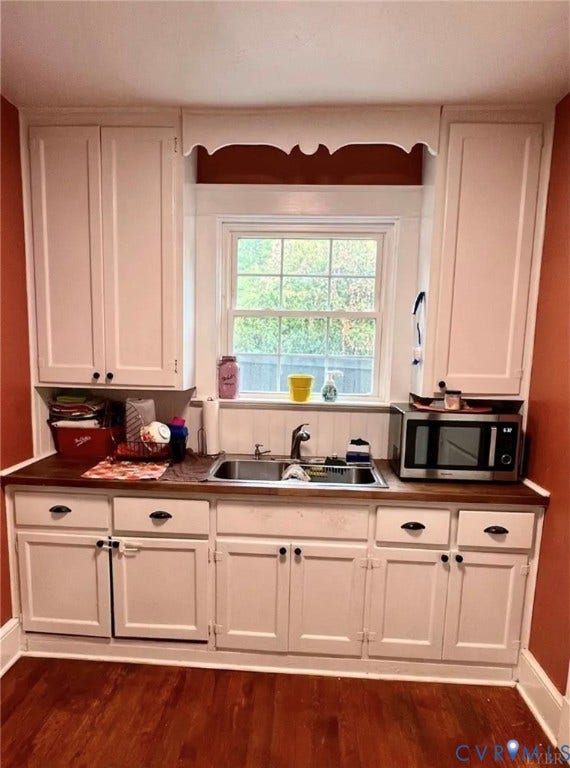 13232 W James Anderson Highway, Courthouse Area, Buckingham, VA 23921 White upper and lower cabinetry, wood-finish countertops, stainless steel double basin sink, and wood-finish flooring