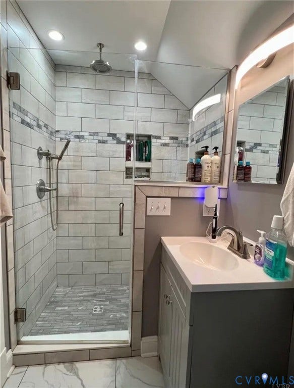 13232 W James Anderson Highway, Courthouse Area, Buckingham, VA 23921 Glass-enclosed shower with subway tile surround, integrated shelving, and a rain showerhead