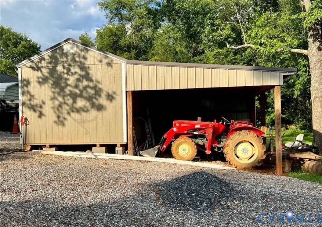 13232 W James Anderson Highway, Courthouse Area, Buckingham, VA 23921 Gabled outbuilding with a metal roof and an attached open-sided storage structure
