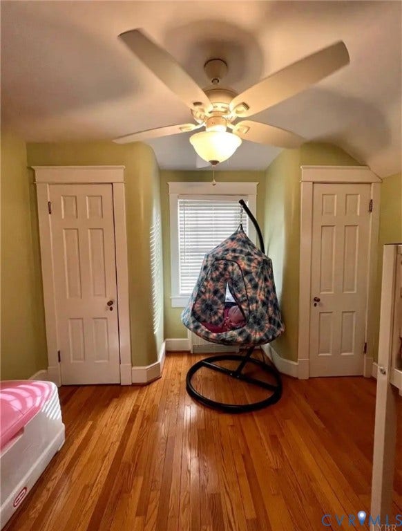 13232 W James Anderson Highway, Courthouse Area, Buckingham, VA 23921 Hardwood flooring, two panel doors, window with blinds, ceiling fan with integrated lighting, and sloped ceiling details