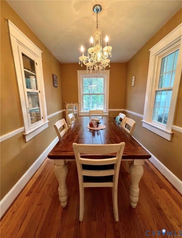 13232 W James Anderson Highway, Courthouse Area, Buckingham, VA 23921 Hardwood flooring, decorative chandelier, white trim, and built-in cabinetry