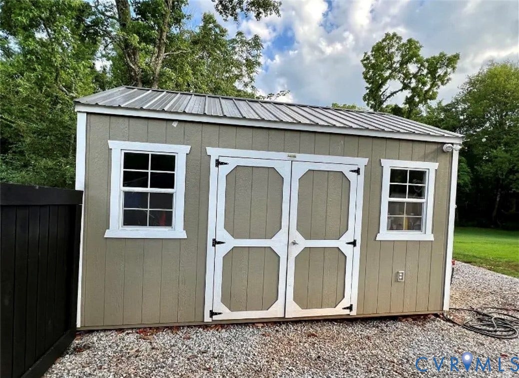 13232 W James Anderson Highway, Courthouse Area, Buckingham, VA 23921 Accessory building featuring a metal roof, two windows with white trim, double entry doors, and gravel ground cover