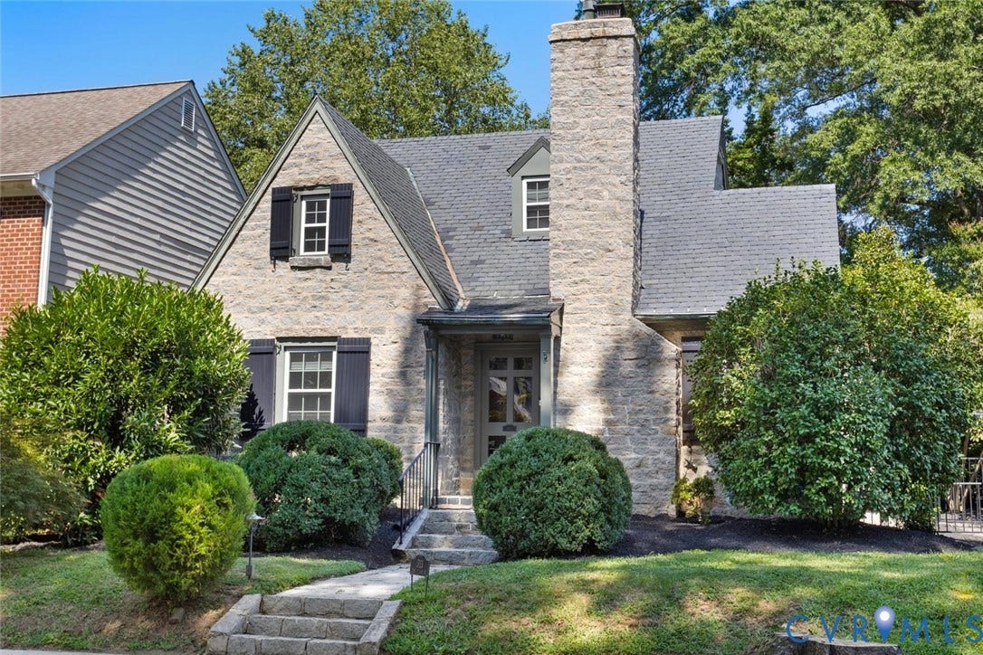 5113 King William Road, Westover Hills, Richmond, VA 23225 Stone exterior with a prominent stone chimney, dark shingle roof, and shuttered windows