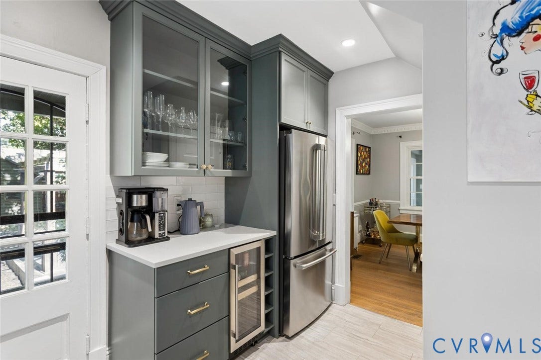 5113 King William Road, Westover Hills, Richmond, VA 23225 Integrated stainless steel refrigerator, built-in beverage cooler, white subway tile backsplash, light-toned countertops, and grey cabinetry with gold-toned hardware