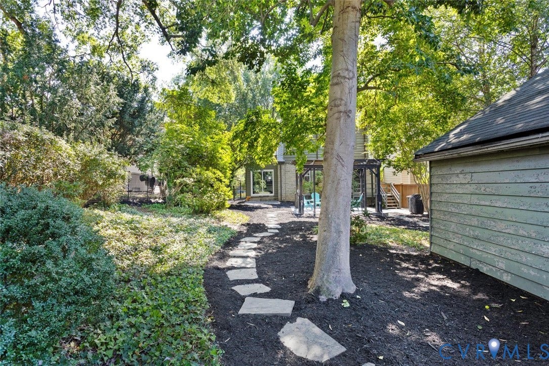 5113 King William Road, Westover Hills, Richmond, VA 23225 Mature trees, stepping stone pathway, extensive ground cover, and a detached structure with siding