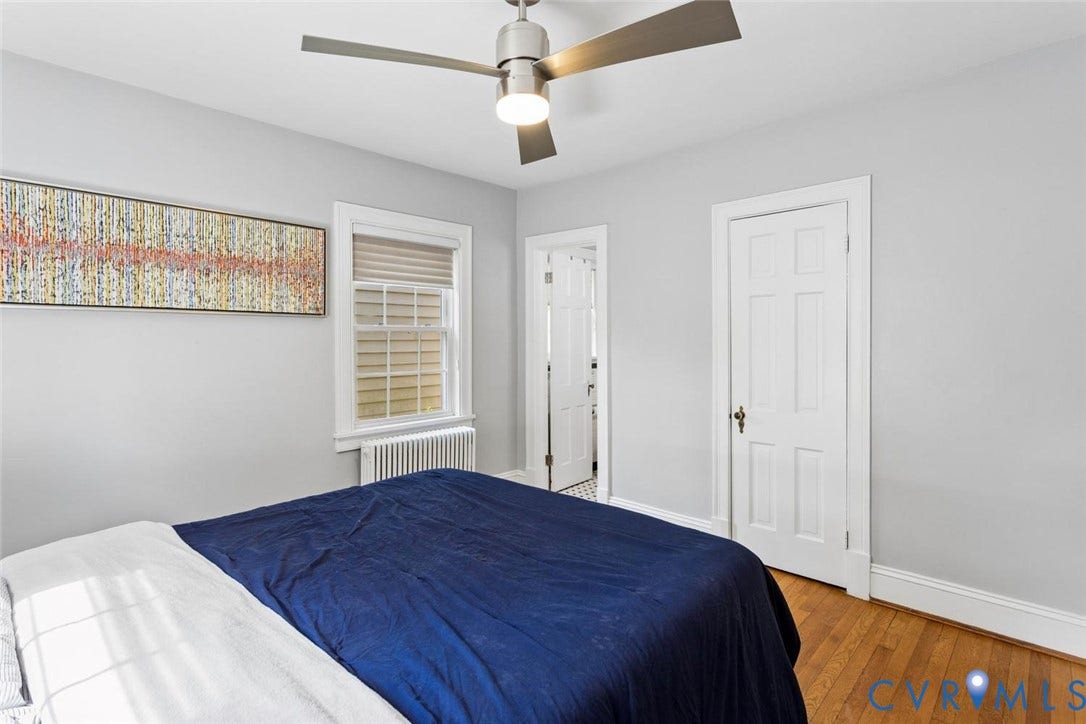 5113 King William Road, Westover Hills, Richmond, VA 23225 Hardwood flooring, multi-pane window with blinds, ceiling fan with integrated lighting, white paneled door, and radiator