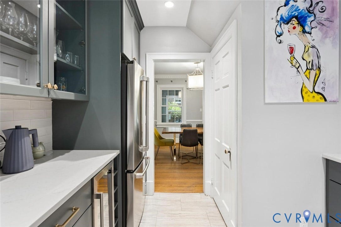 5113 King William Road, Westover Hills, Richmond, VA 23225 Stainless steel refrigerator, white subway tile backsplash, white countertops, dark cabinetry, and gold-tone hardware