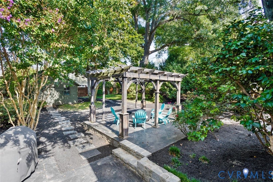 5113 King William Road, Westover Hills, Richmond, VA 23225 Expansive patio featuring a wooden pergola, stone paver steps, and a stone retaining wall