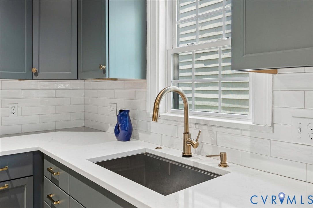 5113 King William Road, Westover Hills, Richmond, VA 23225 White subway tile backsplash, white countertop, stainless steel undermount sink, and bronze-finish faucet