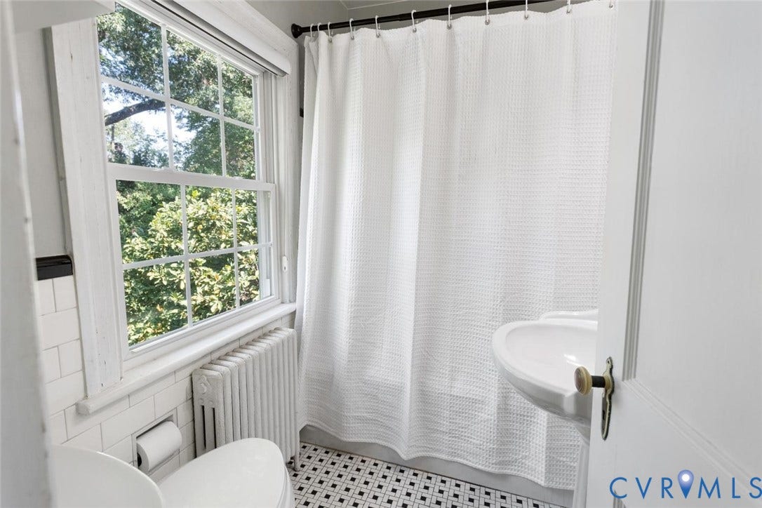 5113 King William Road, Westover Hills, Richmond, VA 23225 Bathroom featuring a pedestal sink, black and white floor tiles, white subway tile wainscoting, and a multi-pane window