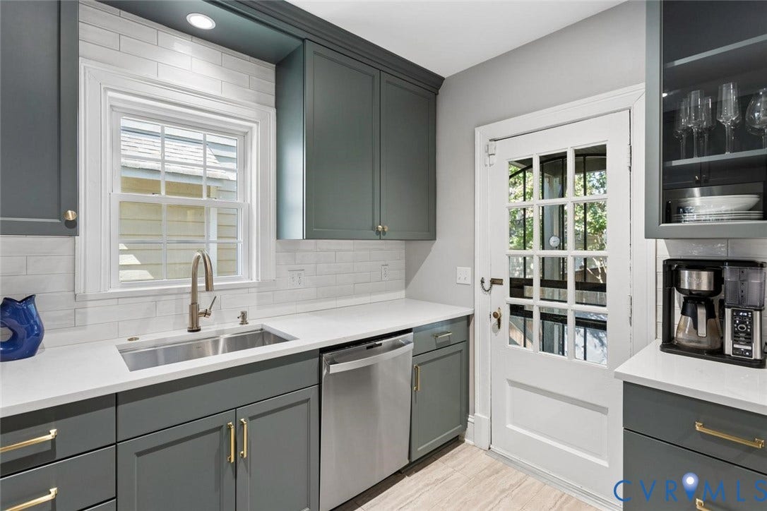 5113 King William Road, Westover Hills, Richmond, VA 23225 Custom cabinetry with gold-tone hardware, white countertop, stainless steel sink with a gooseneck faucet, white subway tile backsplash, and a glass-paned door