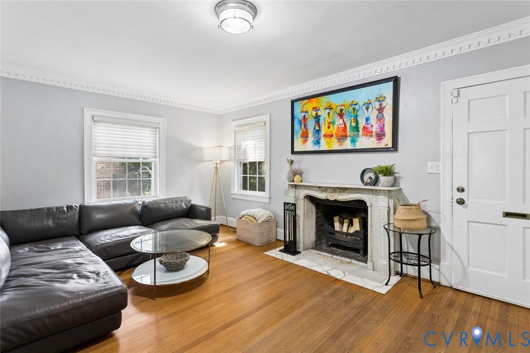 5113 King William Road, Westover Hills, Richmond, VA 23225 Hardwood flooring, decorative crown molding, a built-in fireplace with a stone surround, white trim, and a panel door