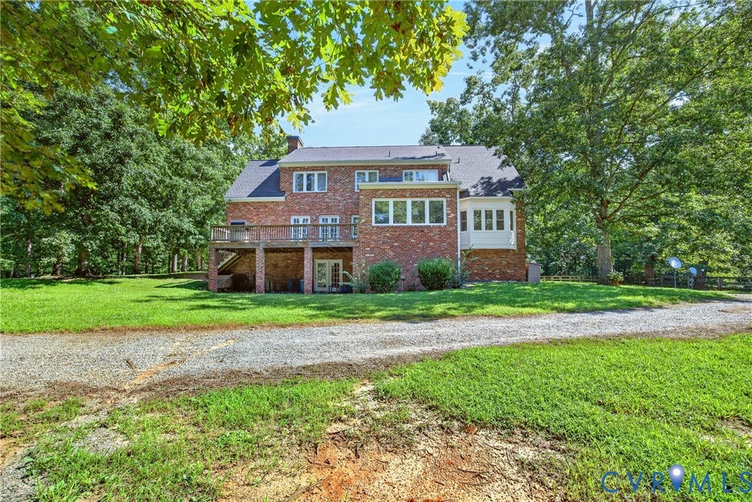 1108 Shallow Well Road, Manakin Sabot, VA 23103 Brick exterior with multiple windows, elevated rear deck, and a lower-level walkout with glass doors