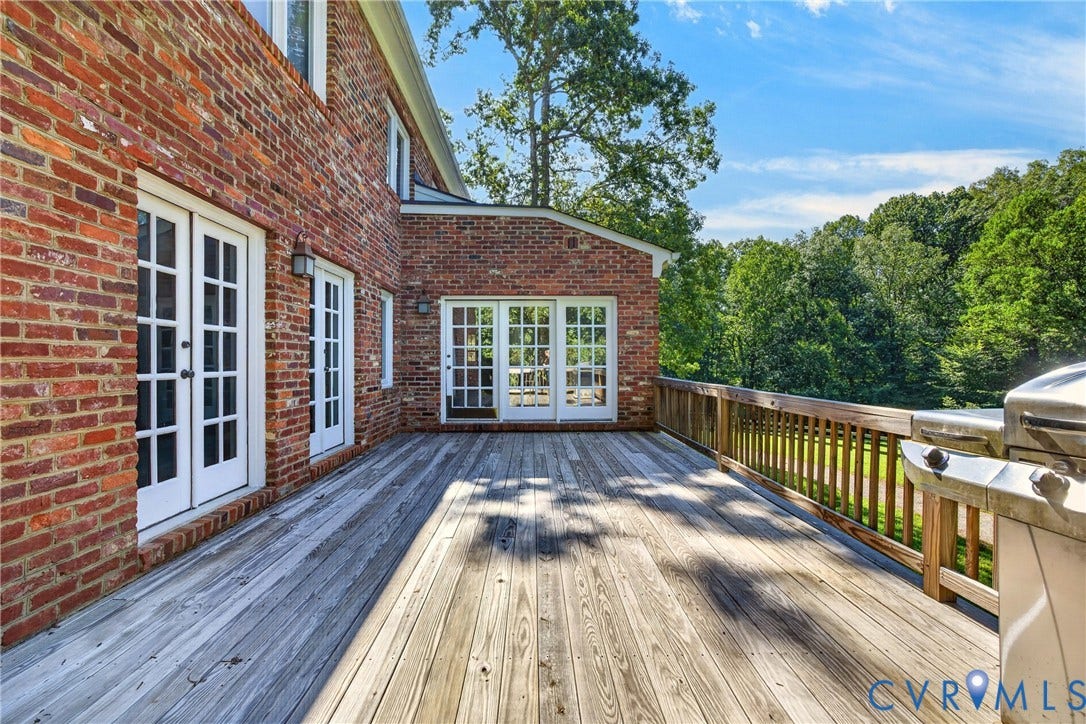 1108 Shallow Well Road, Manakin Sabot, VA 23103 Expansive wood deck with a wood railing and multiple sets of French doors, all set against a brick exterior