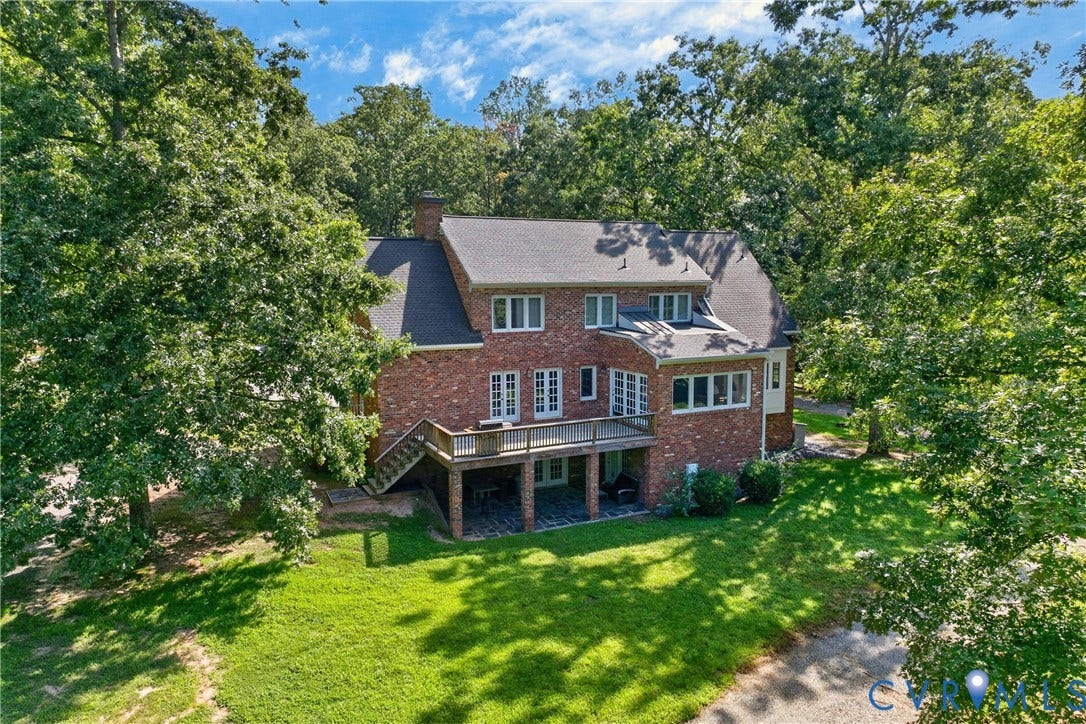 1108 Shallow Well Road, Manakin Sabot, VA 23103 Brick exterior with multiple windows, leading to a spacious deck