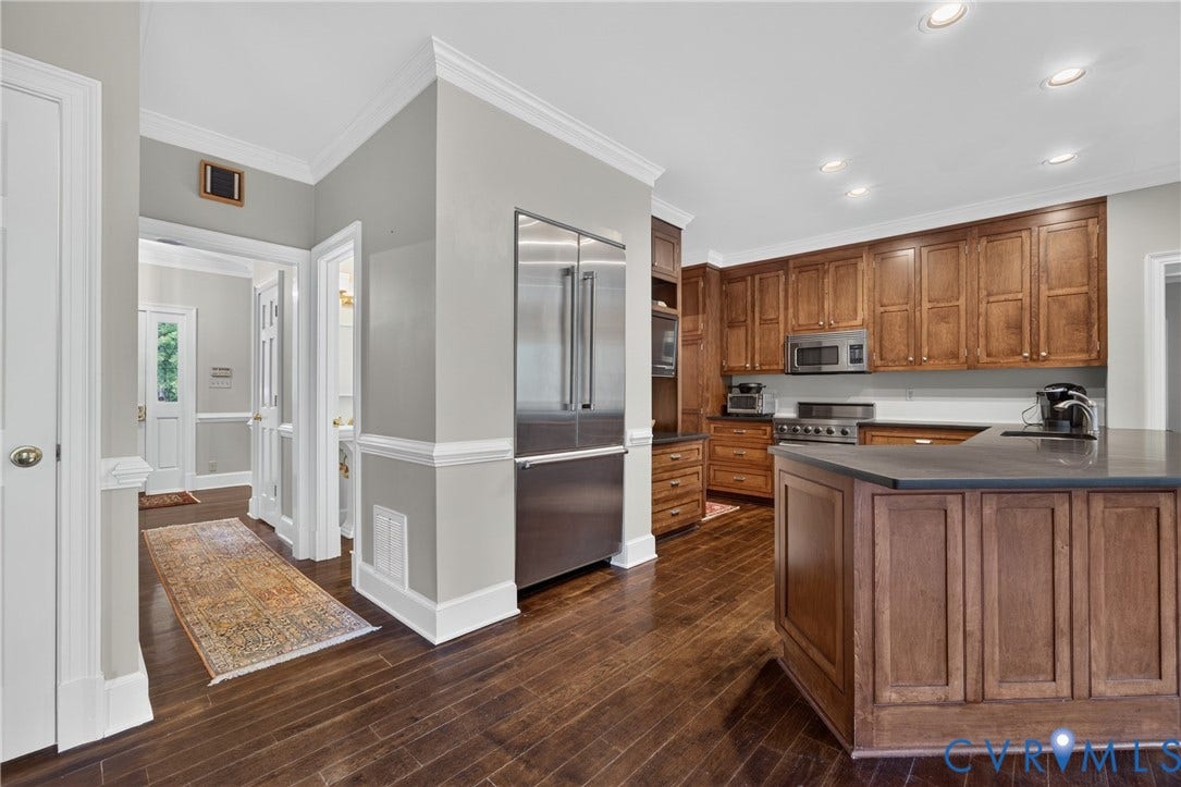 1108 Shallow Well Road, Manakin Sabot, VA 23103 Kitchen featuring wood-finish flooring, built-in stainless steel appliances, recessed lighting, wood cabinetry, and a central island with a dark countertop