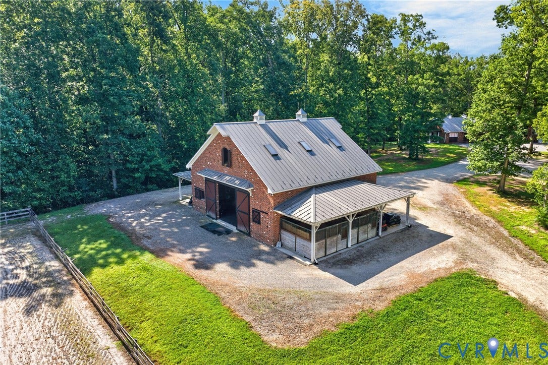 1108 Shallow Well Road, Manakin Sabot, VA 23103 Brick-clad barn structure with a metal roof, cupola, and multiple skylights
