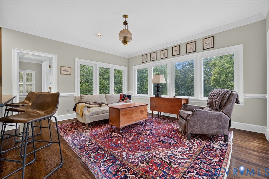 1108 Shallow Well Road, Manakin Sabot, VA 23103 Hardwood flooring, crown molding, chair rail molding, large windows, and an arched doorway