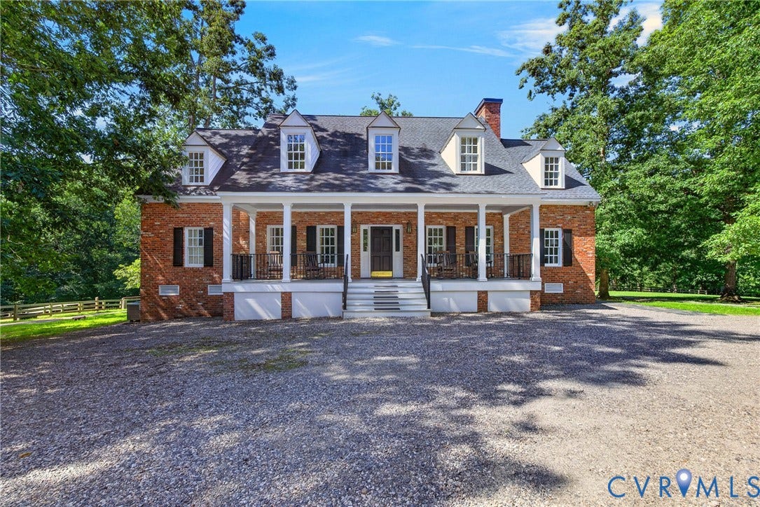 1108 Shallow Well Road, Manakin Sabot, VA 23103 Brick facade residence featuring a covered front porch, white columns, black shutters, and dormer windows