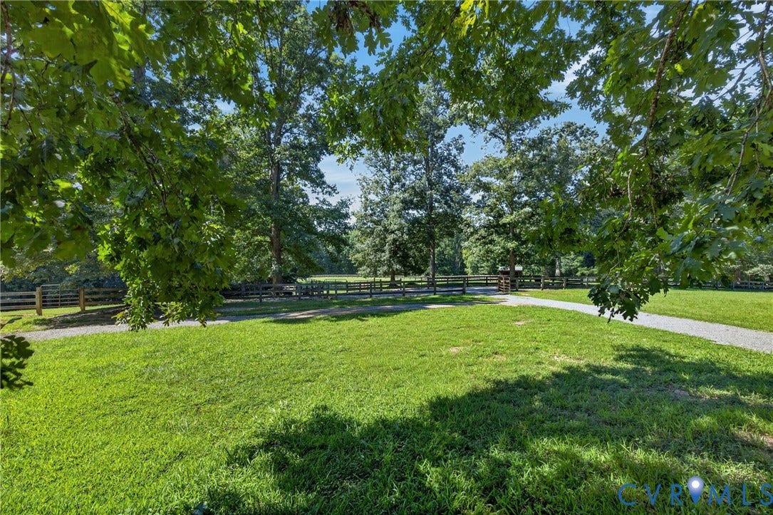 1108 Shallow Well Road, Manakin Sabot, VA 23103 Expansive green lawn with mature trees and a gravel pathway