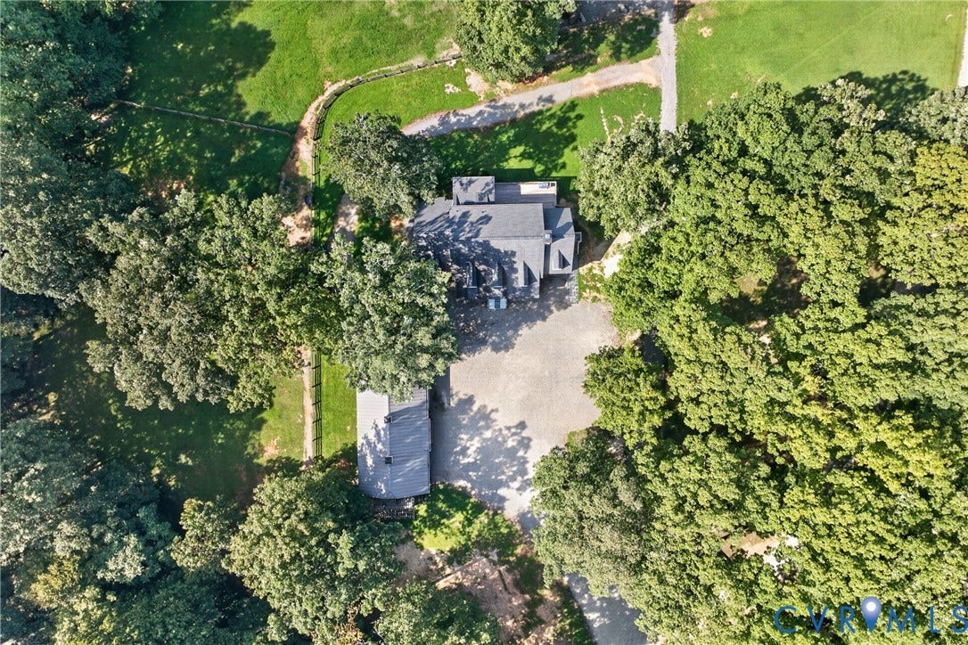1108 Shallow Well Road, Manakin Sabot, VA 23103 Main residence with a dark-pitched roof, surrounded by mature trees, an expansive unpaved drive, and a secondary structure