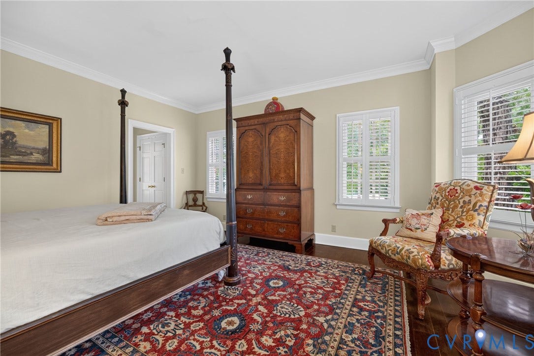1108 Shallow Well Road, Manakin Sabot, VA 23103 Dark wood-finish flooring, white plantation shutters, crown molding, and a paneled interior door