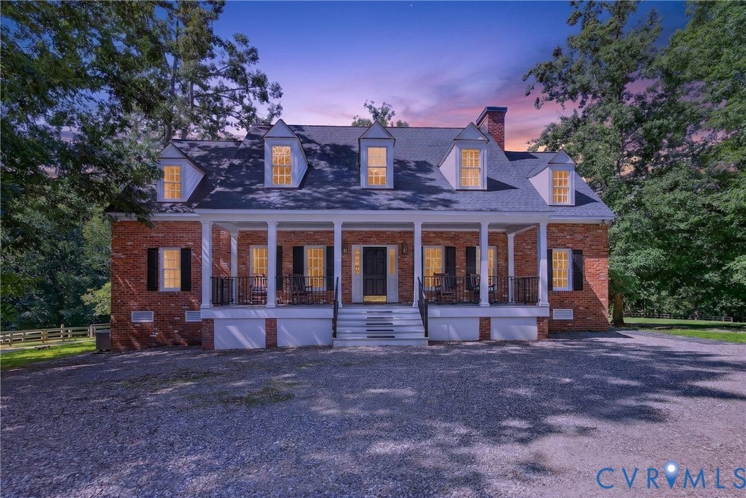 1108 Shallow Well Road, Manakin Sabot, VA 23103 Brick exterior featuring a full-width covered porch, four dormer windows, white columns, and a dark shingle roof