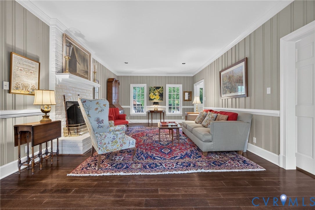 1108 Shallow Well Road, Manakin Sabot, VA 23103 Wood-finish flooring, white brick fireplace, multiple windows, crown molding, and wainscoting