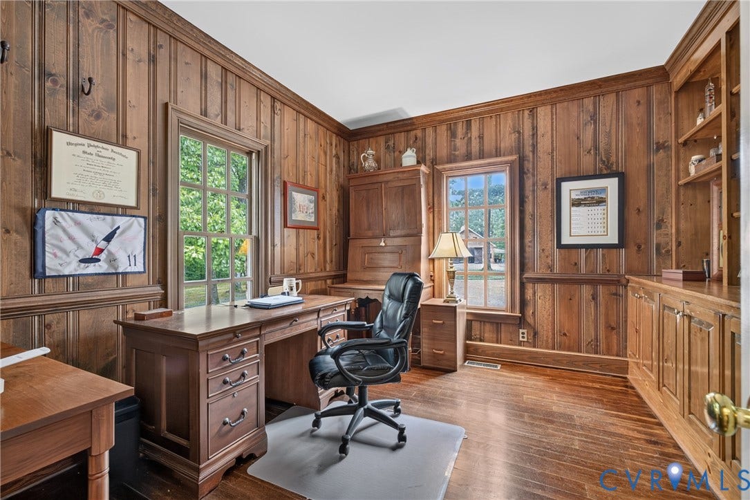 1108 Shallow Well Road, Manakin Sabot, VA 23103 Wood-paneled walls with crown molding, natural wood flooring, two multi-pane windows, and built-in shelving with cabinetry