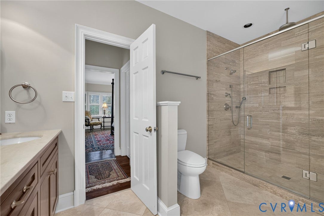 1108 Shallow Well Road, Manakin Sabot, VA 23103 Walk-in shower with clear glass enclosure and stone-finish tile surround, integrated shower niche, and multiple shower heads