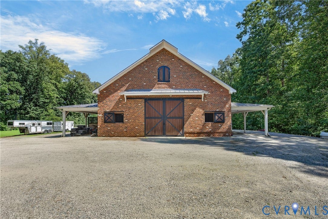 1108 Shallow Well Road, Manakin Sabot, VA 23103 Brick barn structure featuring large wooden sliding doors and an arched upper window