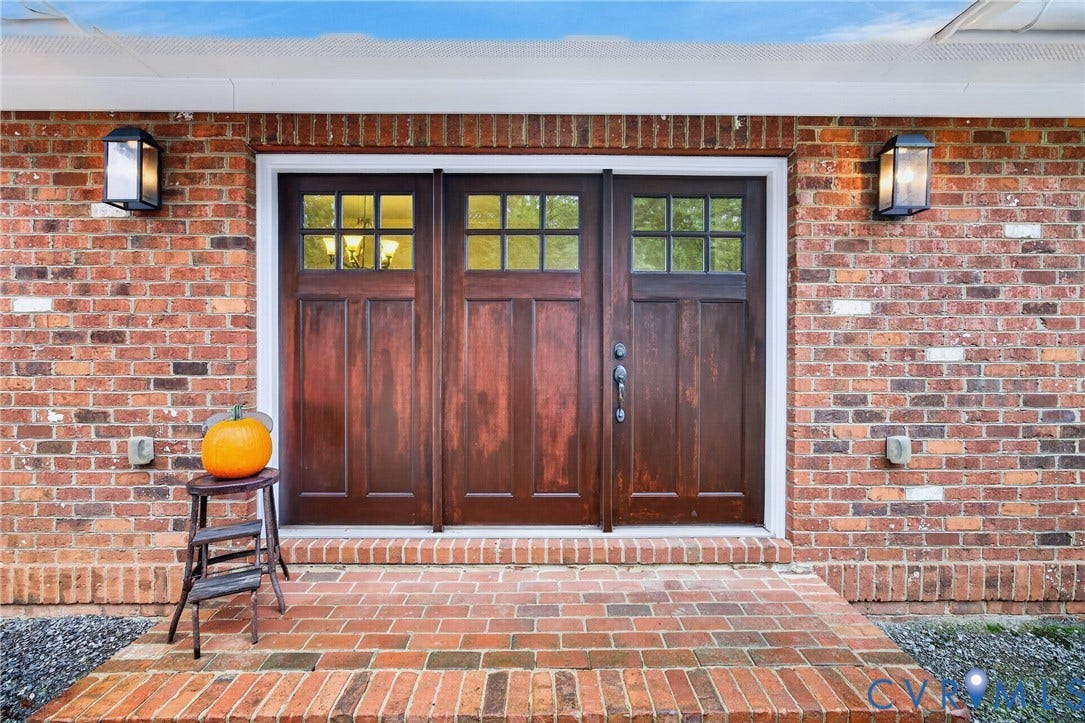 1108 Shallow Well Road, Manakin Sabot, VA 23103 Brick exterior featuring a three-panel wood entry door with upper window panes