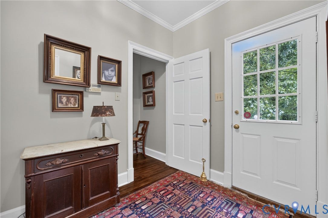 1108 Shallow Well Road, Manakin Sabot, VA 23103 White paneled door with divided lite glass, crown molding, and hardwood flooring