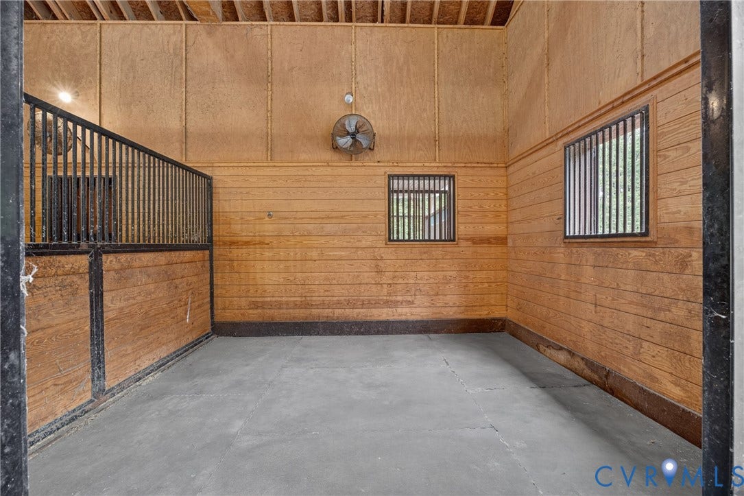 1108 Shallow Well Road, Manakin Sabot, VA 23103 Wood-paneled interior with concrete flooring and barred windows