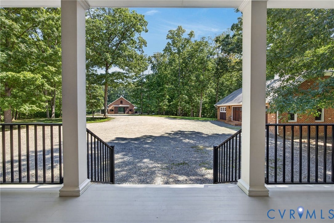 1108 Shallow Well Road, Manakin Sabot, VA 23103 Expansive gravel driveway featuring mature trees and two brick structures