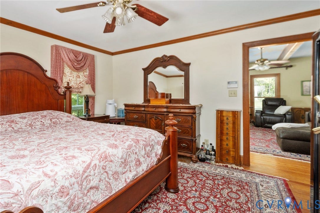 Ceiling fan with wood-finish blades, crown molding, and wood-trim door frames