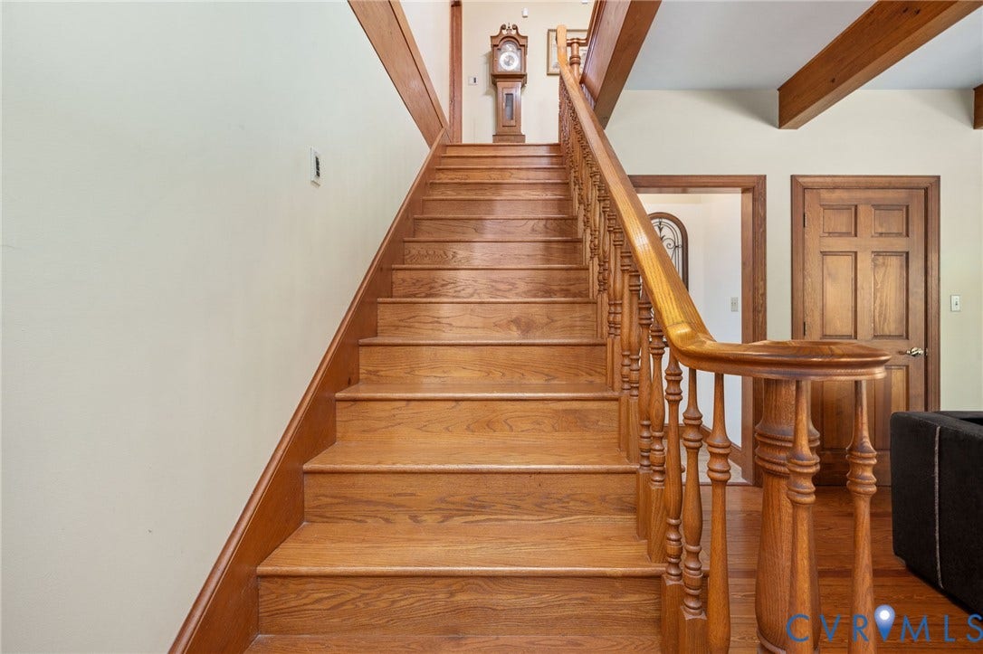 Hardwood staircase with turned wood balusters and railing