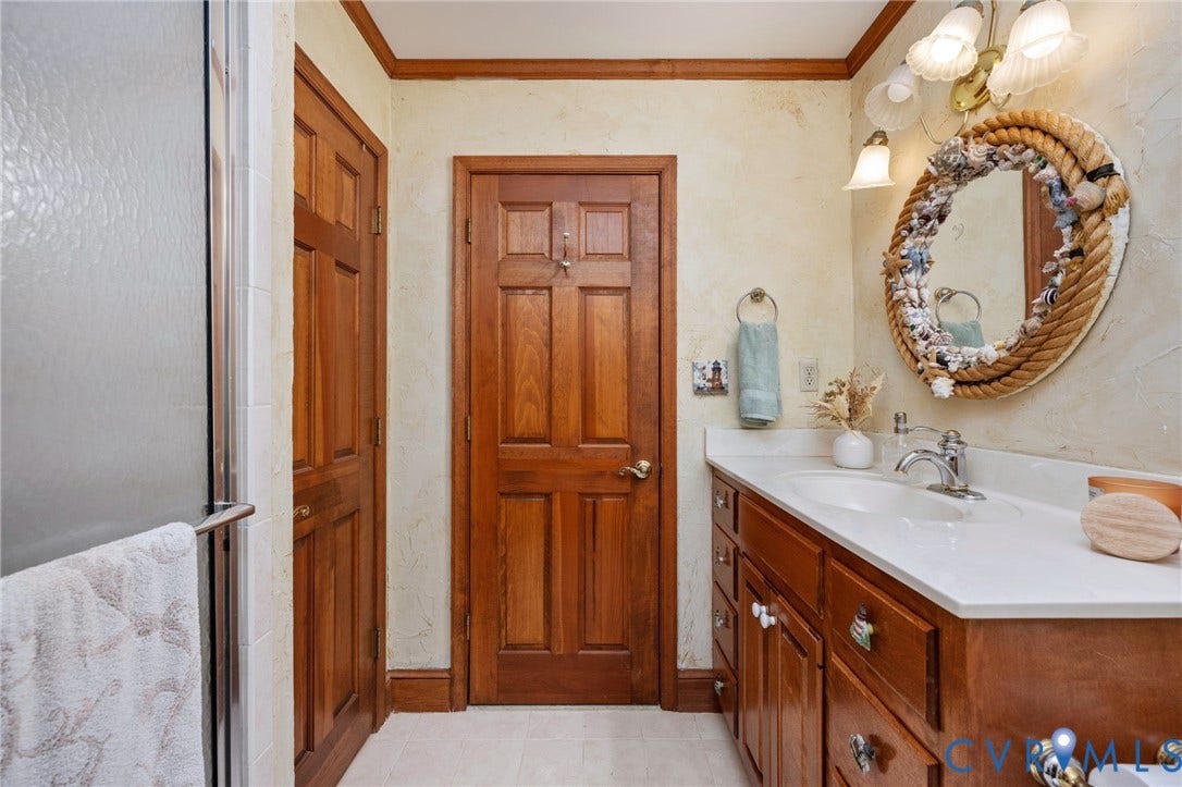 Wood-finish vanity with an integrated sink and chrome fixtures