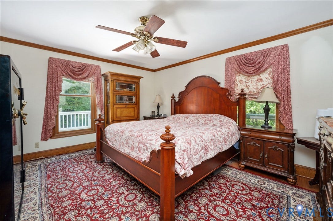 Wood-finish flooring with crown molding and window trim