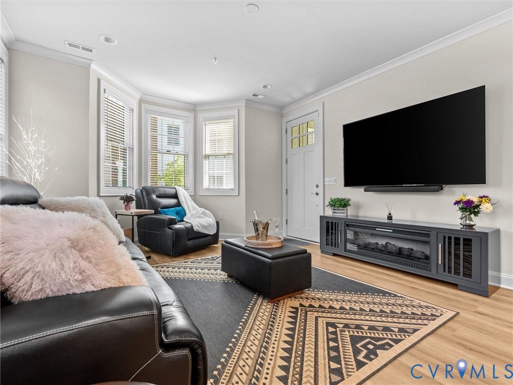 366 Souldren Walk, #A, Short Pump, Henrico, VA 23233 Bay window with multiple panels, recessed lighting, wood-finish flooring, white paneled door with glass inserts, and a built-in media console with an electric fireplace