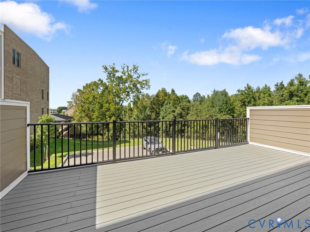 366 Souldren Walk, #A, Short Pump, Henrico, VA 23233 Expansive outdoor deck featuring composite decking, black metal railings, and tan siding, faces the south, so perfect sunsets