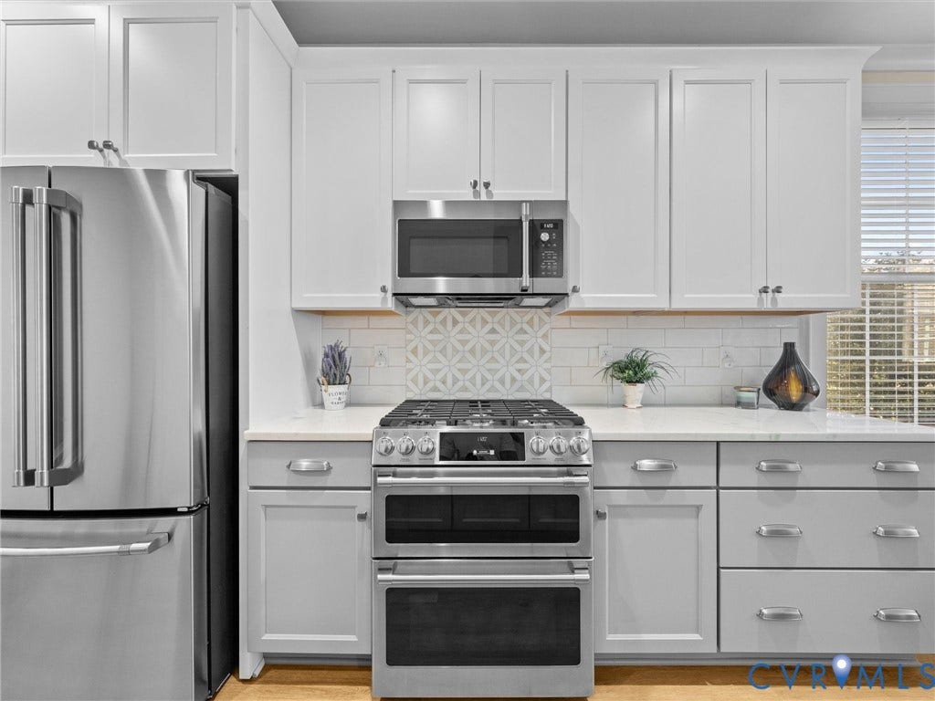 366 Souldren Walk, #A, Short Pump, Henrico, VA 23233 Stainless steel refrigerator, gas range with double oven, built-in microwave, white shaker-style cabinetry, and light-colored countertops