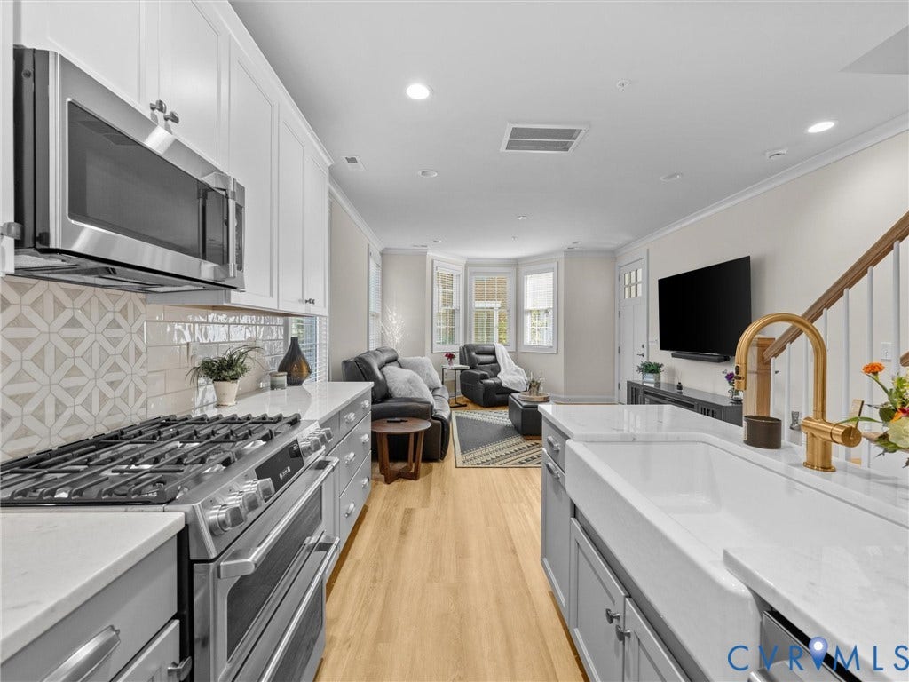 366 Souldren Walk, #A, Short Pump, Henrico, VA 23233 Kitchen featuring a white farmhouse sink, gold-tone faucet, stainless steel appliances, and light wood-finish flooring